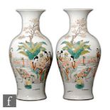 A pair of Chinese 20th Century famille rose vases of baluster form, the white glazed trumpet form