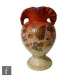 A late 19th Century Harrach vase of footed ovoid form with frilled and folded rim, cased in