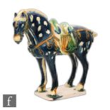 A Tang Dynasty style horse modelled in standing position, with blue glazes picked out in green and