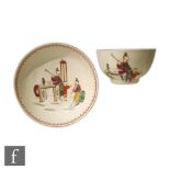 An 18th Century teabowl and saucer decorated with hand painted Chinese figures, one playing a