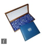 A hallmarked silver cased set of minted silver miniature The Official Flags of The United Nations,