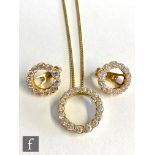 A matching 18ct diamond pendant and earrings, the open circular pendant with eighteen brilliant cut,