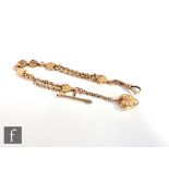 An early 20th Century 9ct rose gold two strand albertina terminating in heart fob, swivel clasp