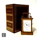 A 20th Century French miniature brass carriage clock by Matthew Norman London, white enameled dial