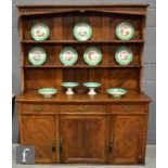 A late 19th Century Arts and Crafts oak dresser, the two-tier plate rack with herringbone style