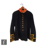 An early 20th Century British Royal Marine dress tunic jacket in black with yellow trim to the cuffs