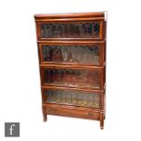 An Edwardian mahogany four sectional bookcase, each section enclosed by leaded light doors over a