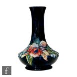 A Moorcroft Pottery vase of compressed globe and shaft form decorated in the Frilled Orchid