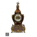 A late 19th Century Louis XIV style gilt metal mounted boudoir clock, circular enamelled dial in