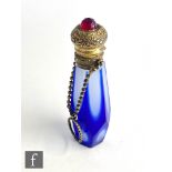 A 20th Century gilt metal mounted scent bottle with white and blue tapering faceted body, the