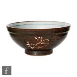 A Japanese studio pottery bowl, the three exterior roundels with white splashed designs, with