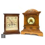 An Edwardian mahogany mantle clock with bevelled glass sides and silvered dial and chapter ring
