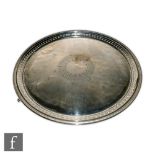 A 19th Century hallmarked silver circular salver with pierced leaf decorated frieze within beaded