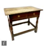 An 18th Century oak side table, the single frieze drawer below a moulded edge top on baluster