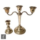 A hallmarked silver three light candelabra, circular stepped base below flaring column and