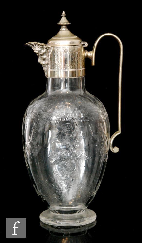 A late 19th Century Stourbridge clear crystal claret jug, possibly Stevens & Williams, of footed,