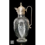 A late 19th Century Stourbridge clear crystal claret jug, possibly Stevens & Williams, of footed,