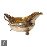 A Swedish silver sauce boat raised of three pierced leaf feet below laurel leaf swag decoration,