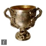 A George IV hallmarked silver twin handled pedestal cup of plain form with applied bifurcated vine