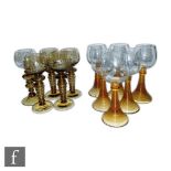 A set of four early 20th century Roemer style wine glasses engraved with fruits and vines and bobbin