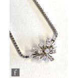 An 18ct white gold diamond necklet with thirteen high claw set brilliant cut diamonds, total