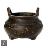 A Chinese 'Gold splash' bronze censer of bombe form, raised on three tripod supports, the dark