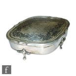 A hallmarked silver cushioned oval trinket box with part foliate decoration to hinged lid, length