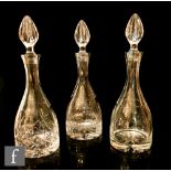 Three contemporary crystal decanters with matched shape and varying pattern designs, height 36cm. (