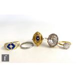Five assorted rings, an 18ct paste set solitaire, a 14ct paste set dress ring, a 9ct paste ring, a