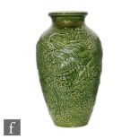 An early 20th Century Bretby shape 9623 vase decorated with a moulded water dragon and sea