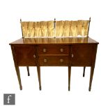 An Edwardian satinwood crossbanded mahogany sideboard, fitted with two central drawers flanked by