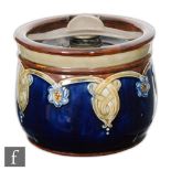 An early 20th Century Royal Doulton Lambeth stoneware tobacco jar and cover of cylindrical form,