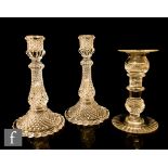 A pair of Baccarat candlesticks with moulded diamond pattern and moulded marks together with a later