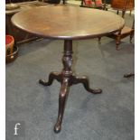 A George III circular mahogany tripod occasional table on turned wrythen pedestal and splayed tripod