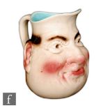 An early 20th Century Sarreguemines character jug modelled as a rosy cheeked man, impressed mark,