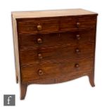 A George IV mahogany veneered chest of two short over three long drawers, raised to French bracket
