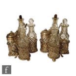 A pair of Victorian hallmarked silver cruet sets each with pierced frames and scroll handles