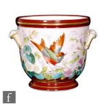 An early 20th Century jardiniere, possibly French, the body hand painted with a bird perched on