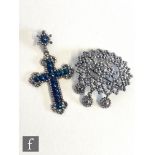 An early 19th Century pierced oval steel drop brooch, width 4.5cm, and a similar blue steel cross,
