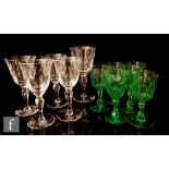 A set of six Edwardian uranium green wine glasses with slice cut bowls and facet cut baluster