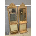 A pair of 19th Century gilt framed pier mirrors, each with a scroll pediment over two bevelled glass