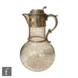 A Victorian hallamrked silver and clear glass claret jug the bulbous plain glass body with cut
