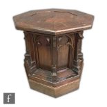 A late 19th Century Gothic Revival ecclesiastical oak font of octagonal form, with stepped arched
