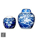 Two 18th/19th Century Chinese blue and white 'Prunus' jars, the first of rounded form with domed