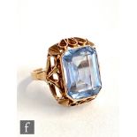 A 14ct single stone blue spinel ring, emerald cut collar set stone,
