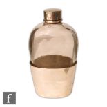 A Victorian hallmarked silver and clear glass hip flask, the silver sleeve to a plain glass body and