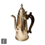 A Queen Anne Britannia silver coffee pot of plain tapering cylindrical form with engraved central