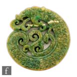 A Chinese green hardstone dragon carving, the reticulated carving modelled as a coiled dragon, the