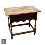A small 18th Century oak side table lacking drawer and the space enclosed by a panel over a shaped