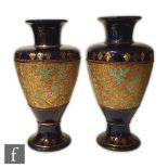 A pair of early 20th Century Doulton Slaters Patent Chine ware vases of footed baluster form with
